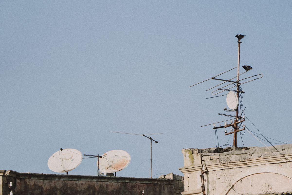 Antennas and satellite dishes on a rooftop