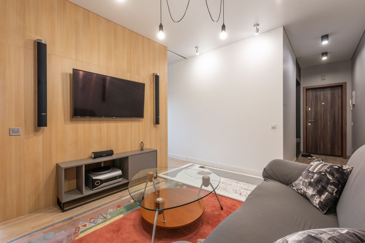 Living room with a TV on the wall and speakers